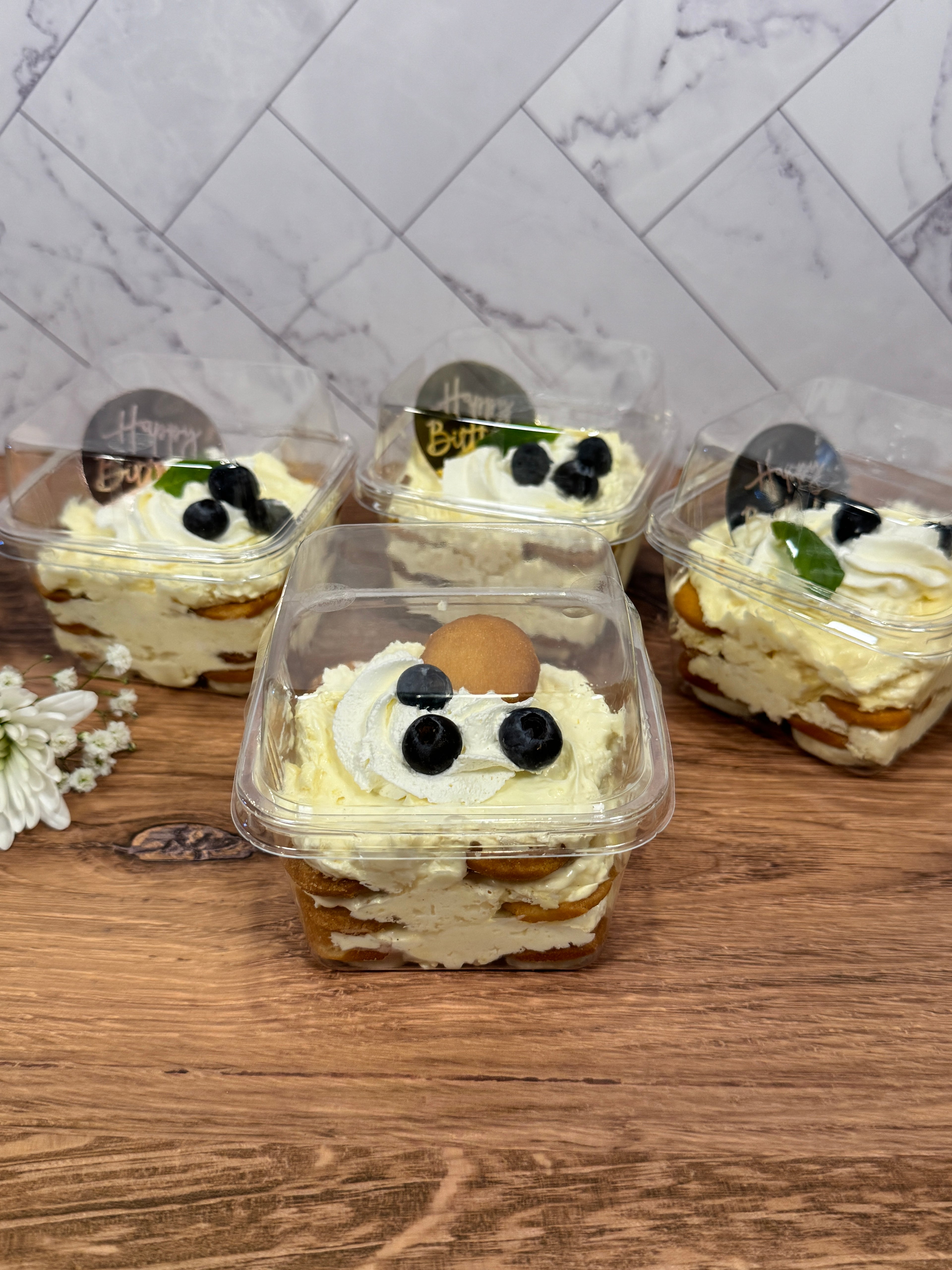 A true Southerner's dream! Layers of ripe bananas, Mini Nilla wafers, rich vanilla bean pudding, and pillowy whipped cream combine to create a fluffy, multi-layer banana pudding, giftable as 12 jumbo, 8oz individual servings in clear, square, lidded containers (as shown) or 12 8oz - 24 4oz servings per clear covered serving bowl options.